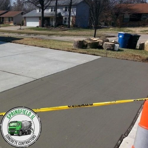 Driveway extension project in Springfield, IL with matching concrete finish.